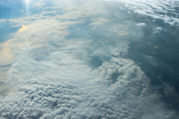 beautiful view from the plane window. Flying over the clouds and the sea.