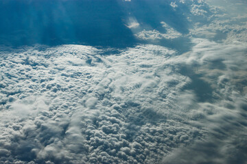beautiful view from the plane window. Flying over the clouds and the sea.