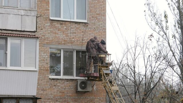 Workers Standing Inside Telescopic Boom Lift 

