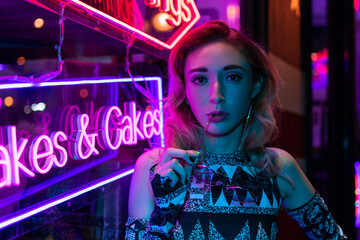 Cinematic night portrait of girl and neon lights
