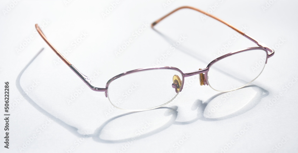 Wall mural longsighted prescription glasses with shadow arranging on white background