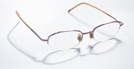 longsighted prescription glasses with shadow arranging on white background