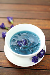 palm fruit with butterfly pea syrup on wooden table