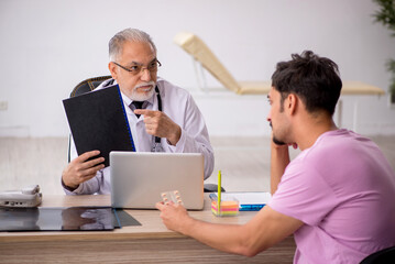 Young male patient visiting old male doctor