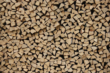 Wooden background or texture for your interior design. Chopped birch firewood