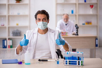 Two male chemist working at the lab