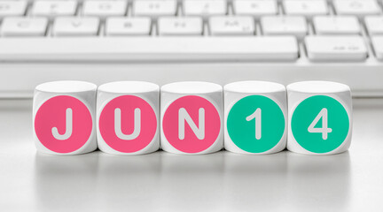 Letter dice in front of a keyboard - June 14