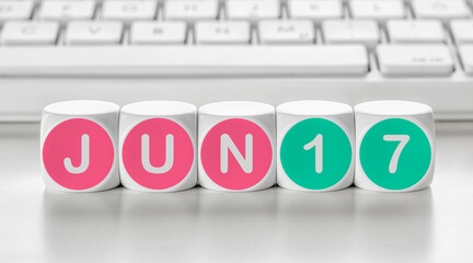 Letter dice in front of a keyboard - June 17