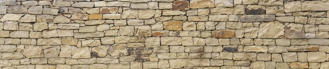 Obraz premium horizontal background, texture - wall of roughly hewn natural light stone