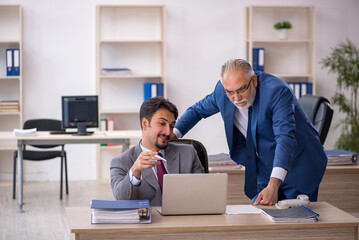 Two male colleagues working in the office