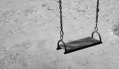 abandoned swings in a city empty swing black and white photo childhood psychology memories