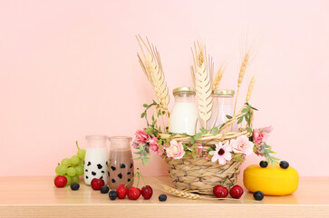 Photo of dairy products over wooden table. Symbols of jewish holiday - Shavuot