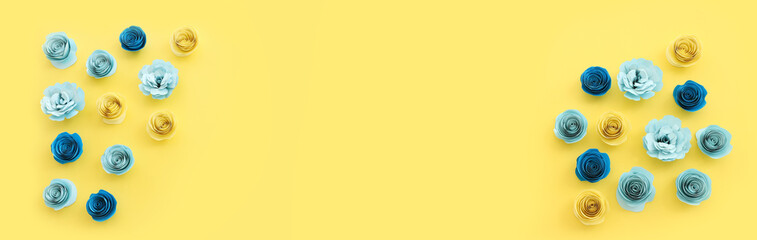 Top view image of paper flowers composition over yellow background