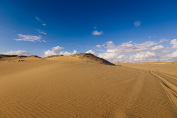 Fototapeta na wymiar Sandy Hills in the White Desert Protected Area, is National park in the Farafra Oasis, Egypt