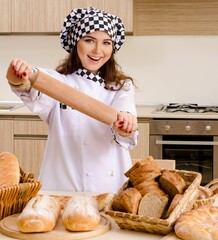 Young female baker working in kitchen