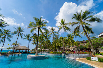 Fototapeta na wymiar Amazing tropical paradise beach with swimming pools and coconut palms