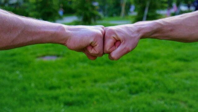 Fists of man on the street. Selective focus.