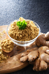 A bowl with ground ginger and its fresh rhizome