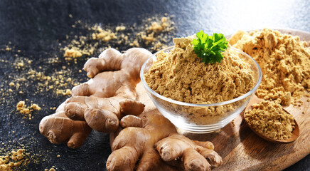 A bowl with ground ginger and its fresh rhizome
