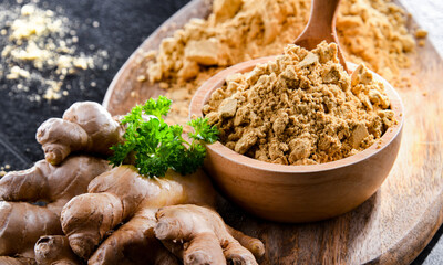 A bowl with ground ginger and its fresh rhizome