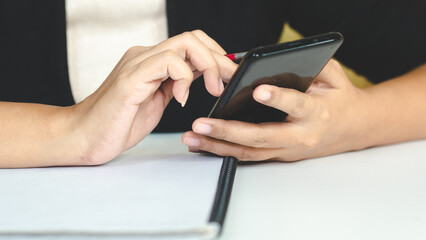 close up hand woman use the smarthphone for work.business technology concept