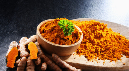Composition with a bowl of ground turmeric and its fresh rhizome