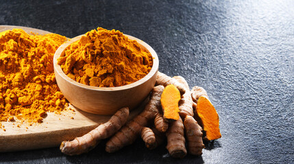 Composition with a bowl of ground turmeric and its fresh rhizome