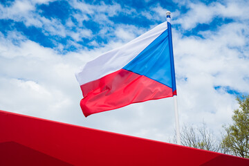Flag of Czech Republic on white cloudy sky background. Czech flag waving in wind. 