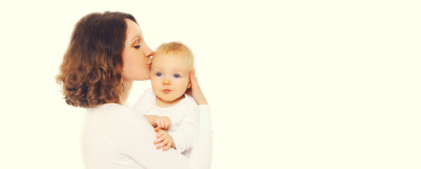 Portrait of happy mother holding and kissing her cute baby on white background, blank copy space for advertising text