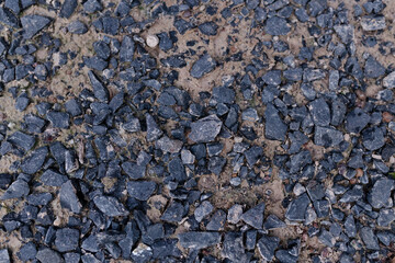 Several black stones on the ground