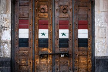 Closed shop door with syrian flag on market in Damascus, Syria