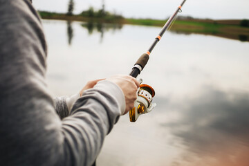 Fishing rod isolated on lake background. Man catching fish with a rod. Fishing equipment...