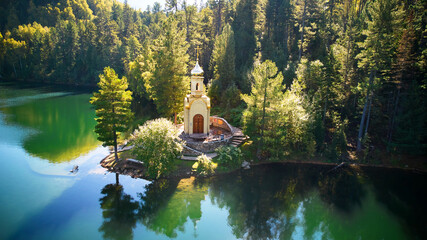 Aerial view of Orthodox Chapel of the Holy Prophet Solomon on the shore of a Emerald Lake among the...