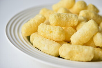 Sugar yellow corn sticks on a plate