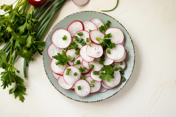 Vegetarian vegetable salad of radish, cucumbers, lettuce salad and flax seeds. Healthy vegan food. Top view