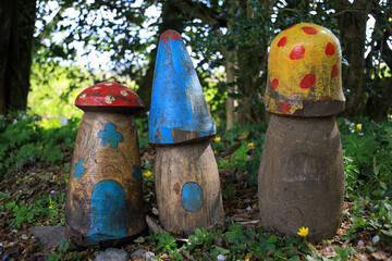 Colourful wooden mushrooms or toadstools in fairy garden