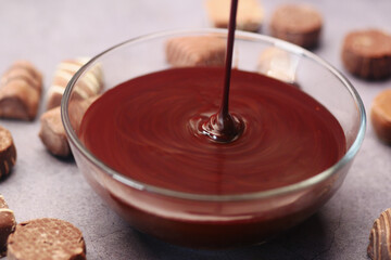 dark chocolate cream pouring in a bowl on table 