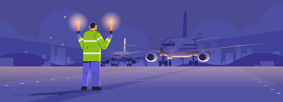 Aviation Marshaller With Light Sticks Near Aircraft Air Traffic Controller Airline Worker In Signal Vest Professional Airport Staff