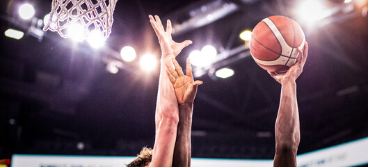 basketball game ball going through hoop