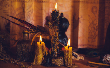 Magical illustration, esoteric concept. Candles and other magical stuff. Wicca and pagan attributes on a table	
