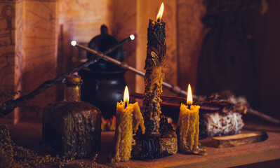 Magical illustration, esoteric concept. Candles and other magical stuff. Wicca and pagan attributes on a table	
