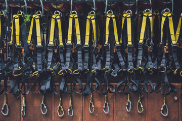 Rows of climbing safety ropes and carabiners and helmets