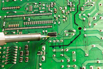Replacing electronic components and parts with a soldering iron and solder Industrial equipment.