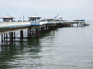 A view along the Grade II listed Llandudno pier in the seaside resort in North Wales, UK.