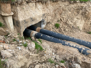 Laying a new water pipe on the street. construction work. Laying a pipeline to provide homes with...