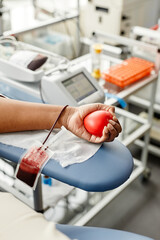 Close up of unrecognizable young woman donating blood and holding red heart copy space