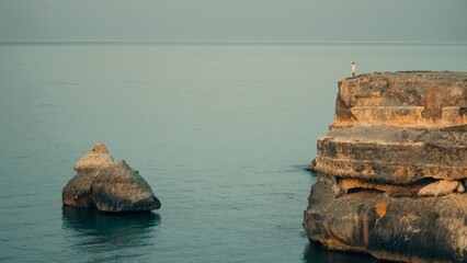 beautiful panorama, that italian paradise in Puglia. there's a big cliff on that beautiful sea. the shooting was made on a blue hour, after sunset, for shooting a natural till and orange effect. - obrazy, fototapety, plakaty