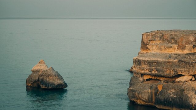 beautiful panorama, that italian paradise in Puglia. there's a big cliff on that beautiful sea. the shooting was made on a blue hour, after sunset, for shooting a natural till and orange effect.