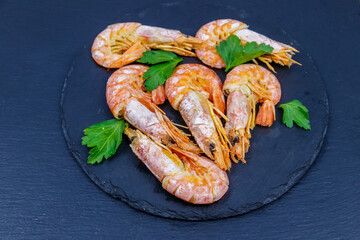 Boiled large langoustines on a black slate