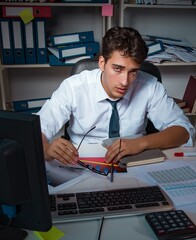 Man businessman working late hours in the office